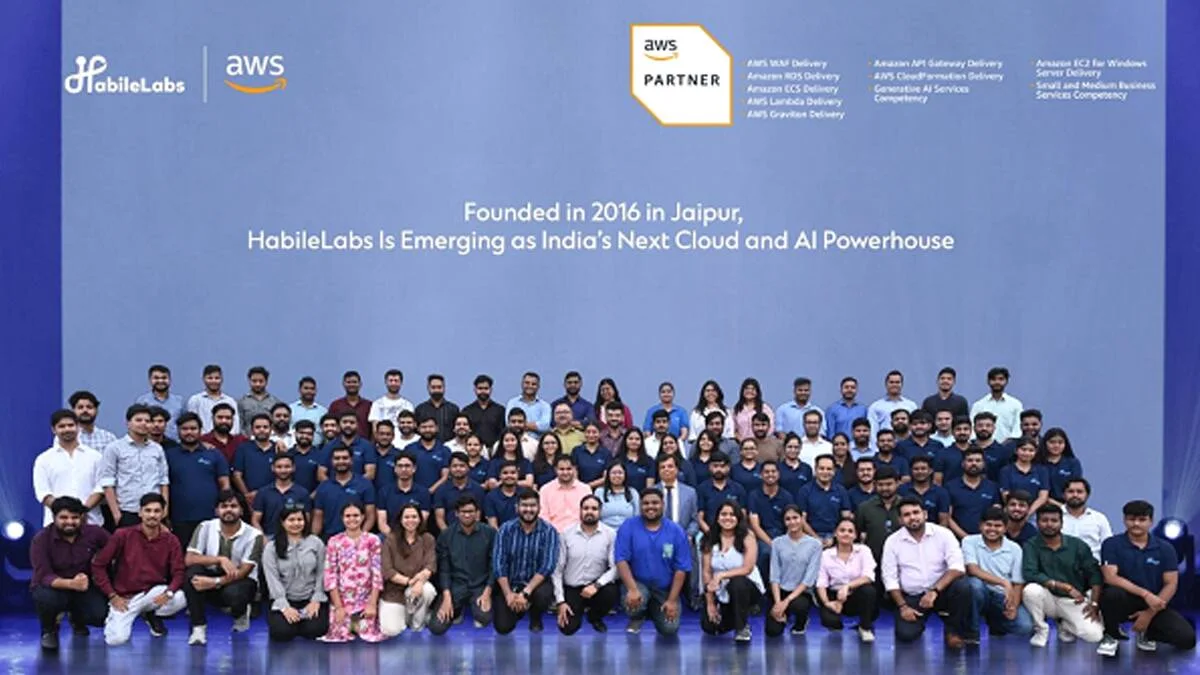 The HabileLabs team on stage, photographed together beneath the HabileLabs and AWS logos